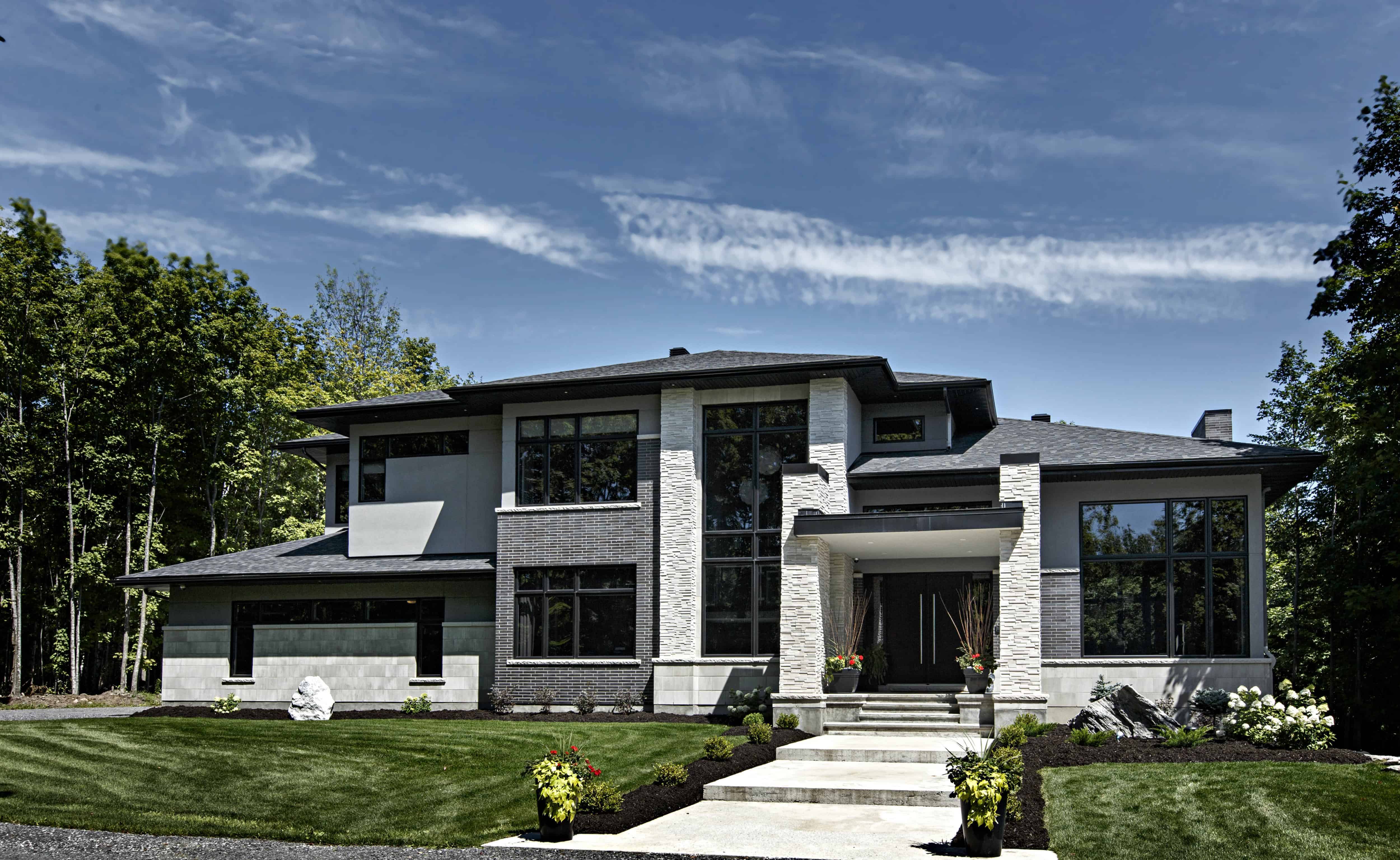 modern home with light colored stone and dark grey brick