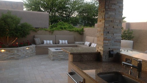 outdoor kitchen fireplace with natural stone cladding and stacked stone panels