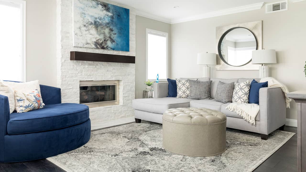 Clean white stone veneer fireplace in a bright living room