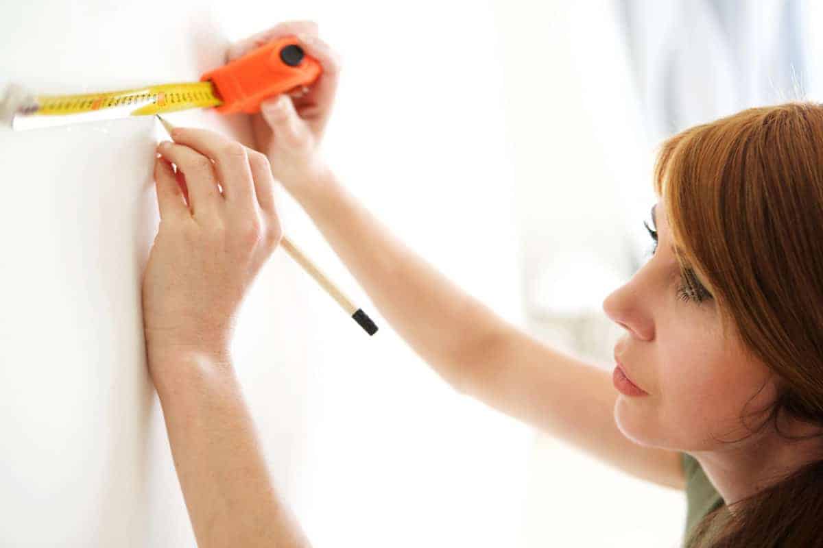 woman measuring for tile