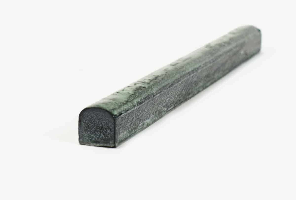 natural stone bullnose trim with green glaze over black limestone and a glossy glaze to finish a natural stone tile project