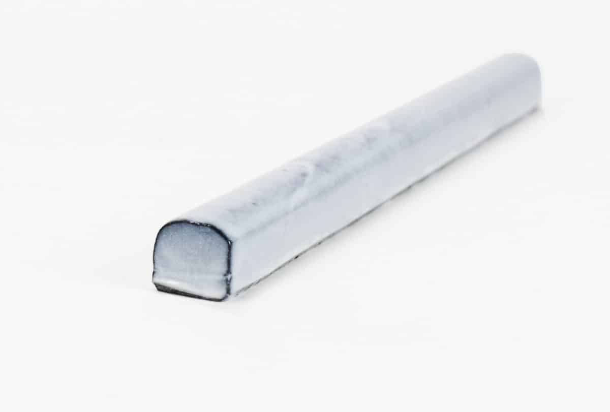Tempered Bullnose Trim Fog natural stone bullnose trim with white glaze over black limestone and a glossy glaze to finish a natural stone tile project