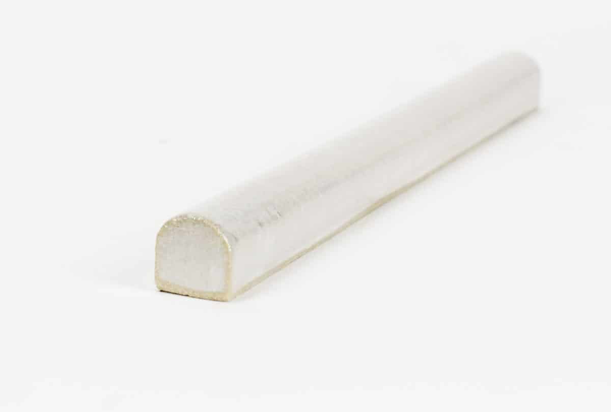 natural stone bullnose trim with white glaze over golden limestone and a glossy glaze to pair with natural stone tile