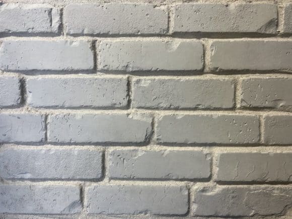 Antique rustic finished faux brick veneer in a white wash brick look