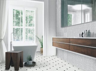 Realstone black and white marble penny tile bathroom backsplash and floor with large window and soaking tub with plants and chunky wooden stool