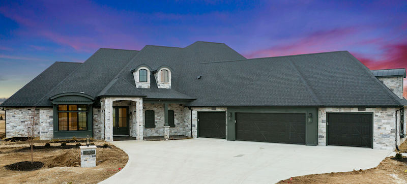 large home with grey faux stone on exterior