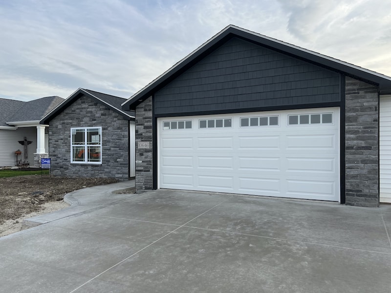 grey faux stone fand siding on home exterior