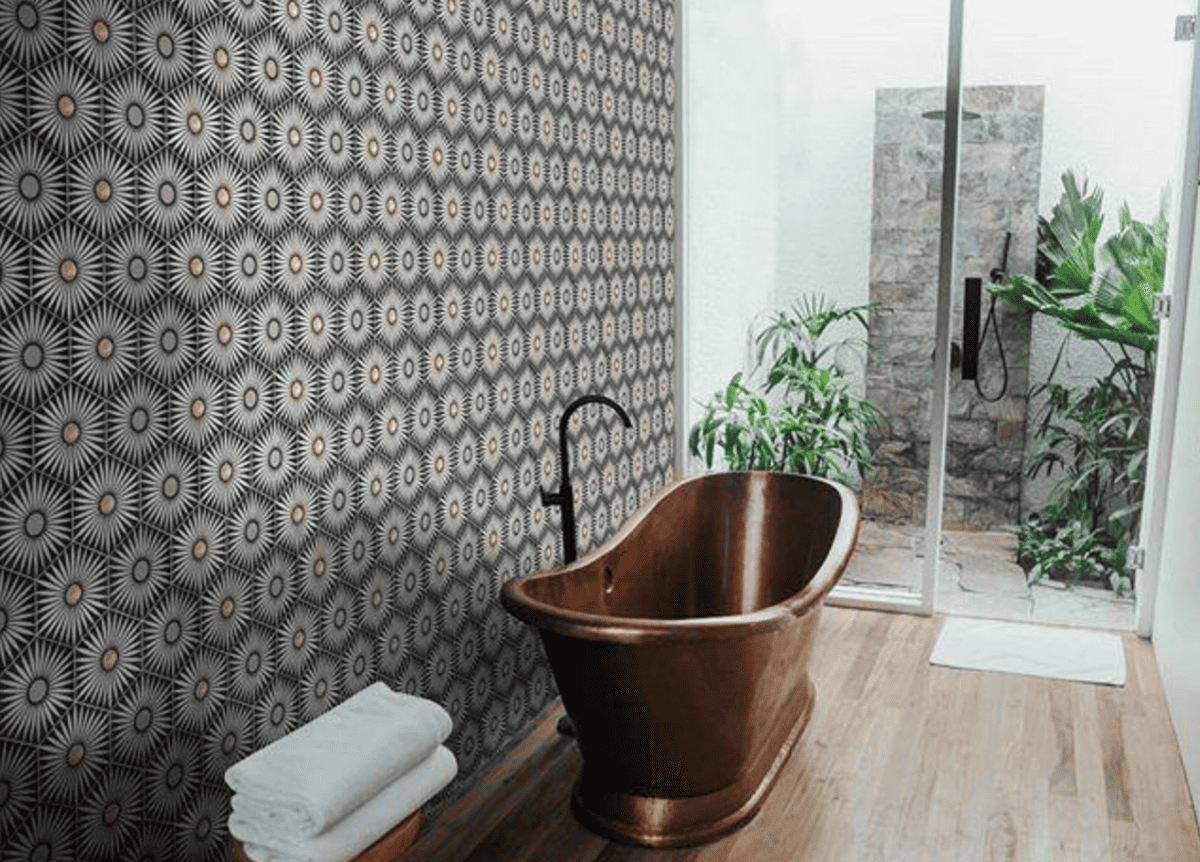 Rise Brass inlay Hexagon Cement Tile in black and white on a bathroom accent wall