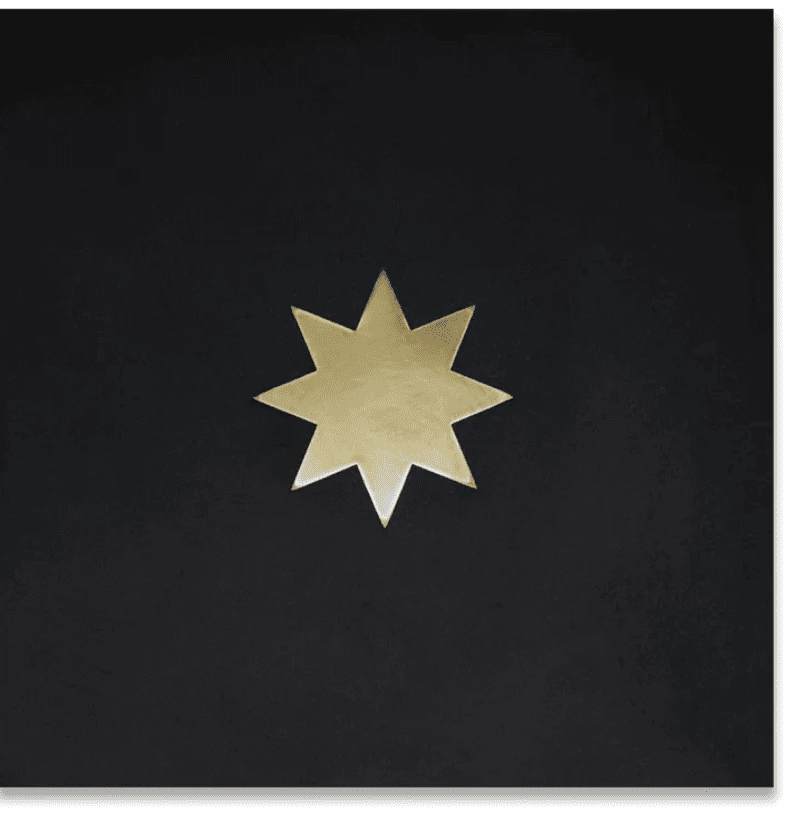 black cement tile with brass star inlay