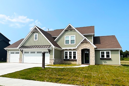 faux stone home exterior with vertical siding