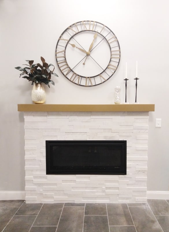 white limestone natural stone veneer fireplace with mantle and raised firebox