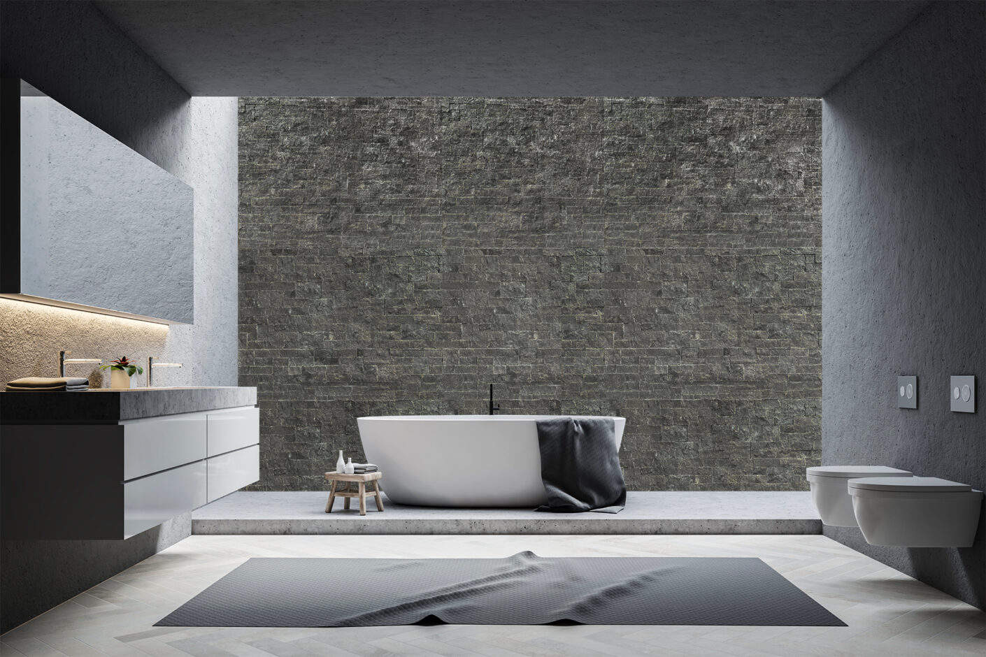 carbon slate colored stone wall in luxurious bathroom with large soaking tub