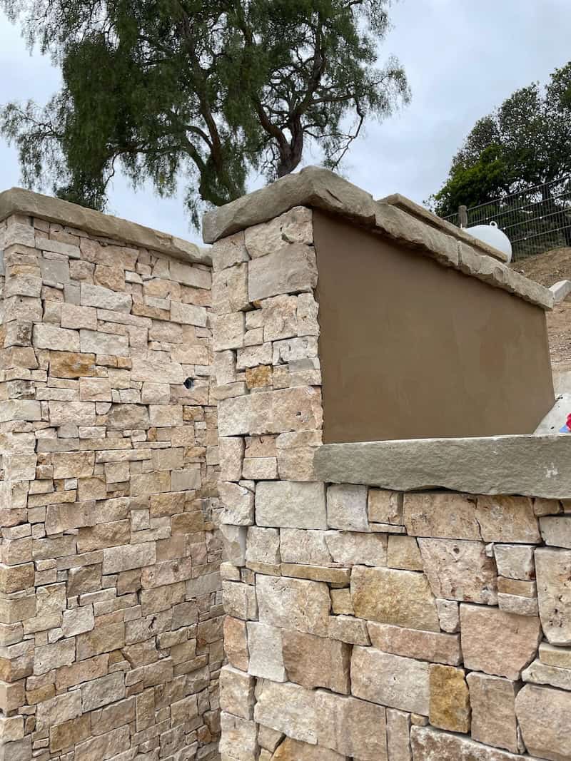Warm toned rustic natural stone exterior wall