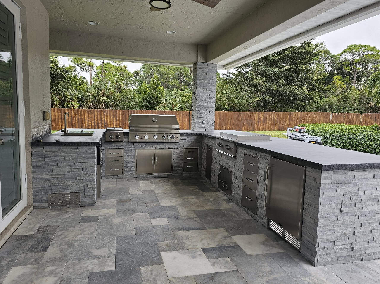 Pewter Ledgestone Realstone stone veneer panels outdoor kitchen island with stacked stone finish and bar seating