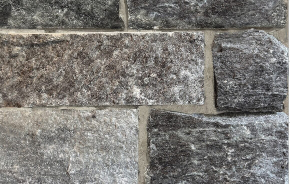 A darker grayed blue stone that has sawn edges in squares for better fitting
