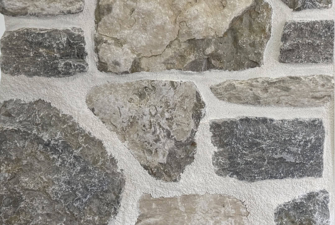 Blend of squared, ledgestone and random shapes. Full bed stone limestone in shades of light grey, gold and blue-grey undertones