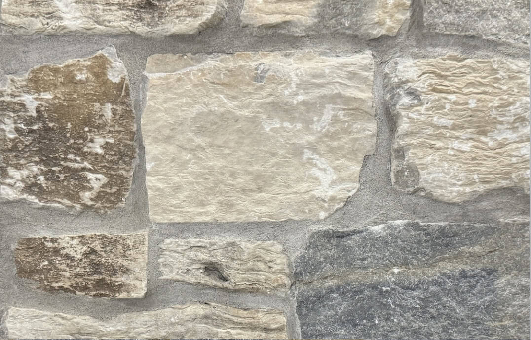 Tumbled finish loose limestone samples in shades of light grey, gold and blue-grey undertones