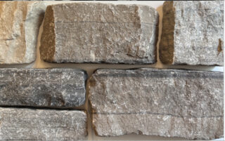 Split ledgestone face in Limestone in a blend of Brown, Grey, Tan, Black with horizontal veining