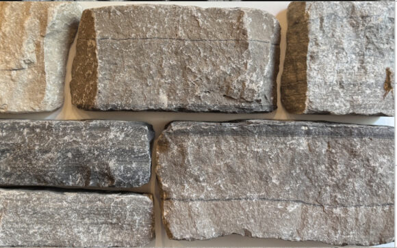 Split ledgestone face in Limestone in a blend of Brown, Grey, Tan, Black with horizontal veining