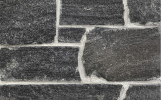 Sawn height loose stone Veneer in Black Granite with Mica sparkle and occasional Brown shading, split face with horizontal veining