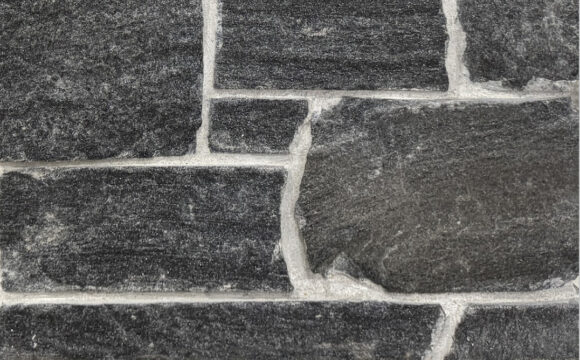 Sawn height loose stone Veneer in Black Granite with Mica sparkle and occasional Brown shading, split face with horizontal veining