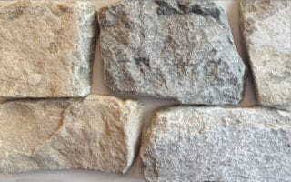 Tumbled finish loose stone limestone in shades of light grey, gold and blue-grey undertones and a reoccurring flat tan piece