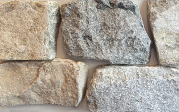 Tumbled finish loose stone limestone in shades of light grey, gold and blue-grey undertones and a reoccurring flat tan piece