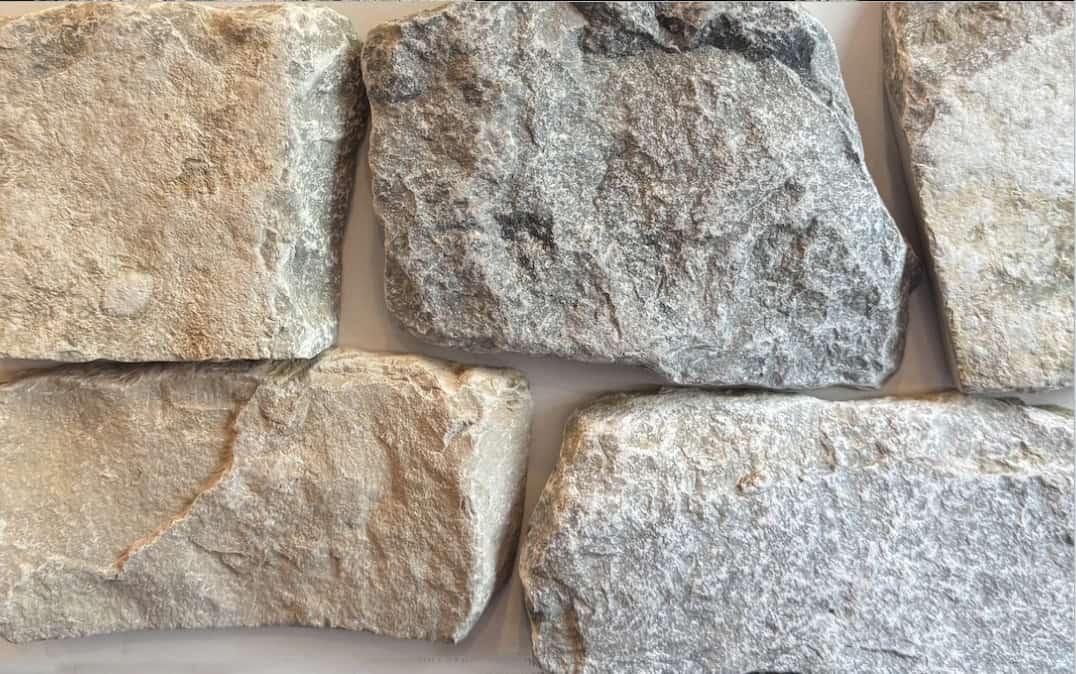 Tumbled finish loose stone limestone in shades of light grey, gold and blue-grey undertones and a reoccurring flat tan piece