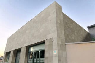 Buff limestone colored beige outdoor porcelain pavers set up for a facade