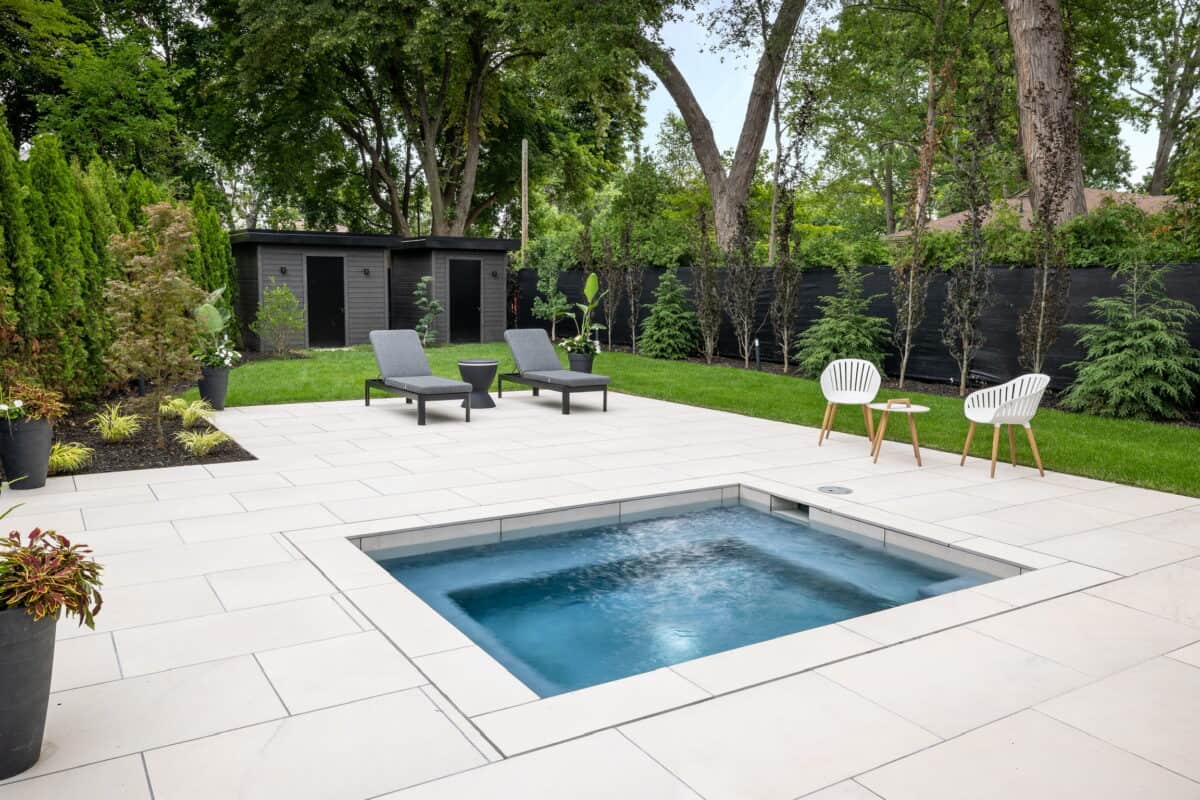 Light Cream or white outdoor porcelain pavers with a slight grey tint to the veining, set up as a walkway for an outdoor pool area for a house