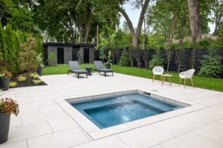 Light Cream or white outdoor porcelain pavers with a slight grey tint to the veining, set up as a walkway for an outdoor pool area for a house