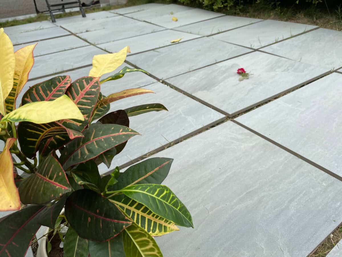 Light gray, outdoor porcelain pavers with a slightly textured surface laid out in a patio format