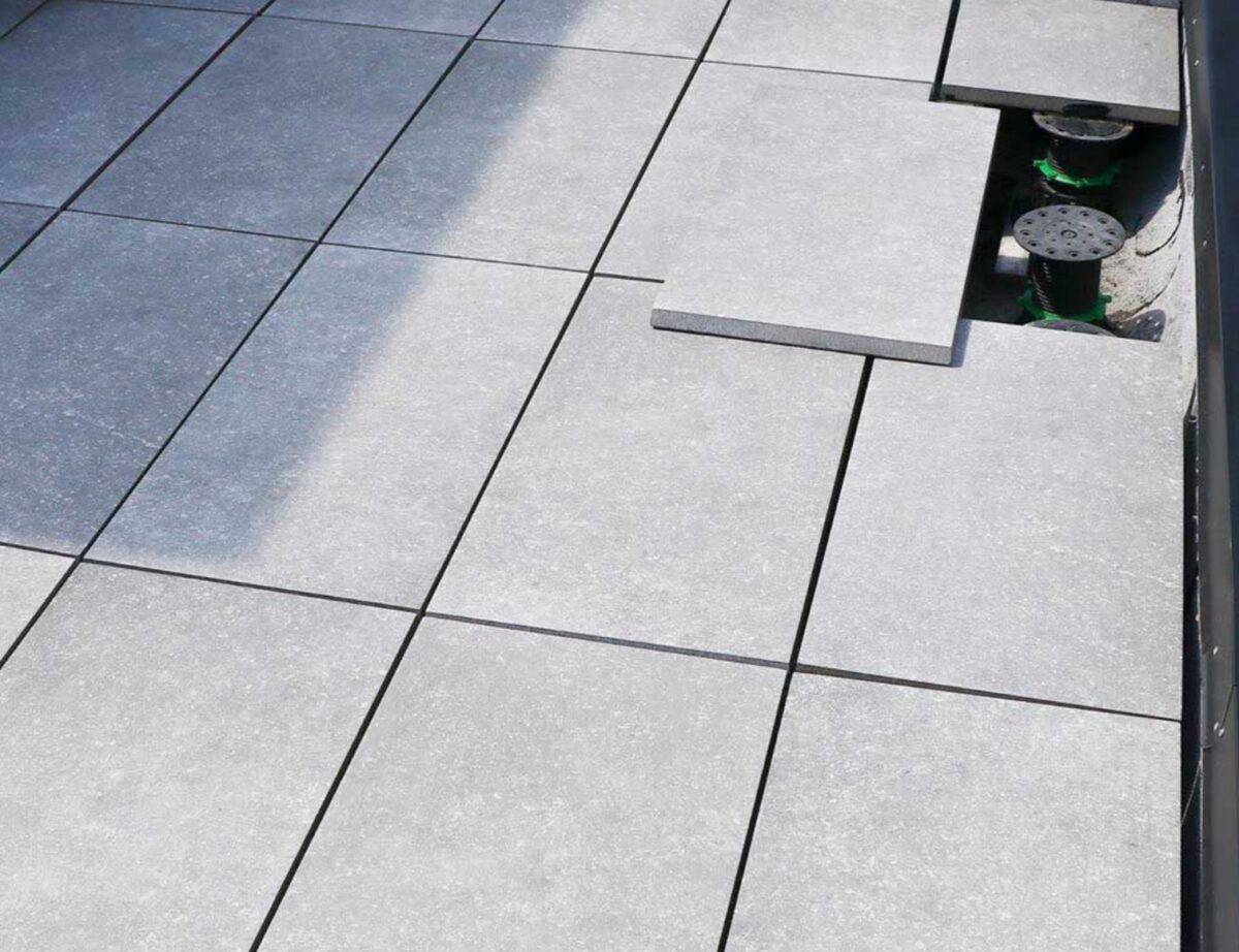 Light grey colored outdoor porcelain pavers that are used to finish rooftop terrace area and outdoor patio
