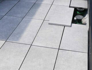 Light grey colored outdoor porcelain pavers that are used to finish rooftop terrace area and outdoor patio
