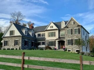 A darker grayed blue stone that has sawn edges in squares for better fitting laid out on the exterior of a home