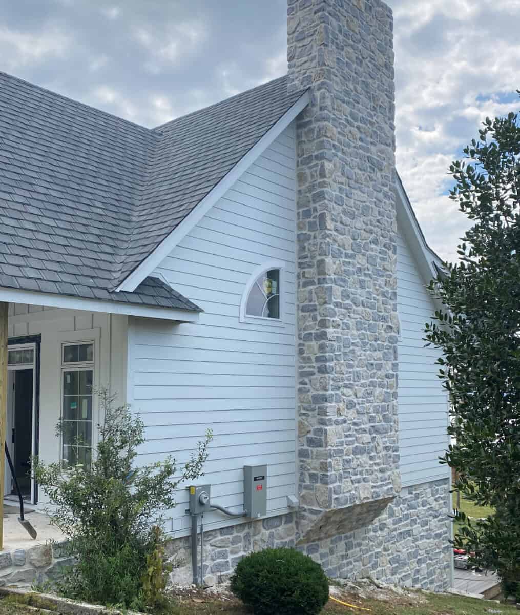 Blend of squared, ledgestone and random shapes. Full bed stone limestone in shades of light grey, gold and blue-grey undertones set up on a fireplace