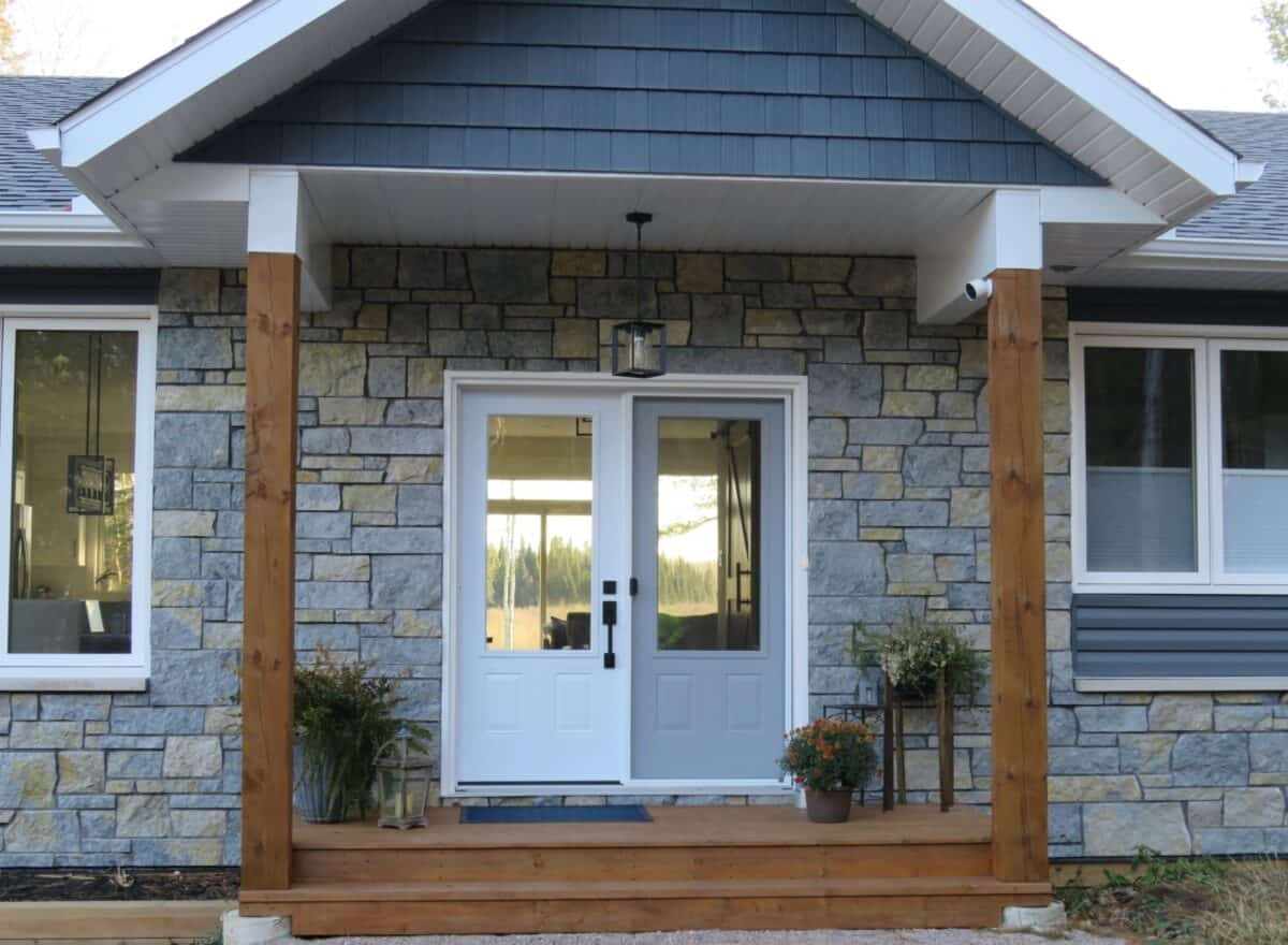Sawn height loose stone limestone in shades of light grey, gold and blue-grey undertones set up for an exterior for a house