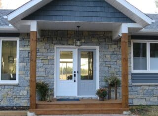 Sawn height loose stone limestone in shades of light grey, gold and blue-grey undertones set up for an exterior for a house