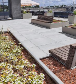 Light gray almost white outdoor porcelain pavers that are stain resistant and maintenance free and are perfectly used for an entryway