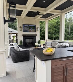 A variety of lighter and darker gray outdoor porcelain pavers laid out in a patio format