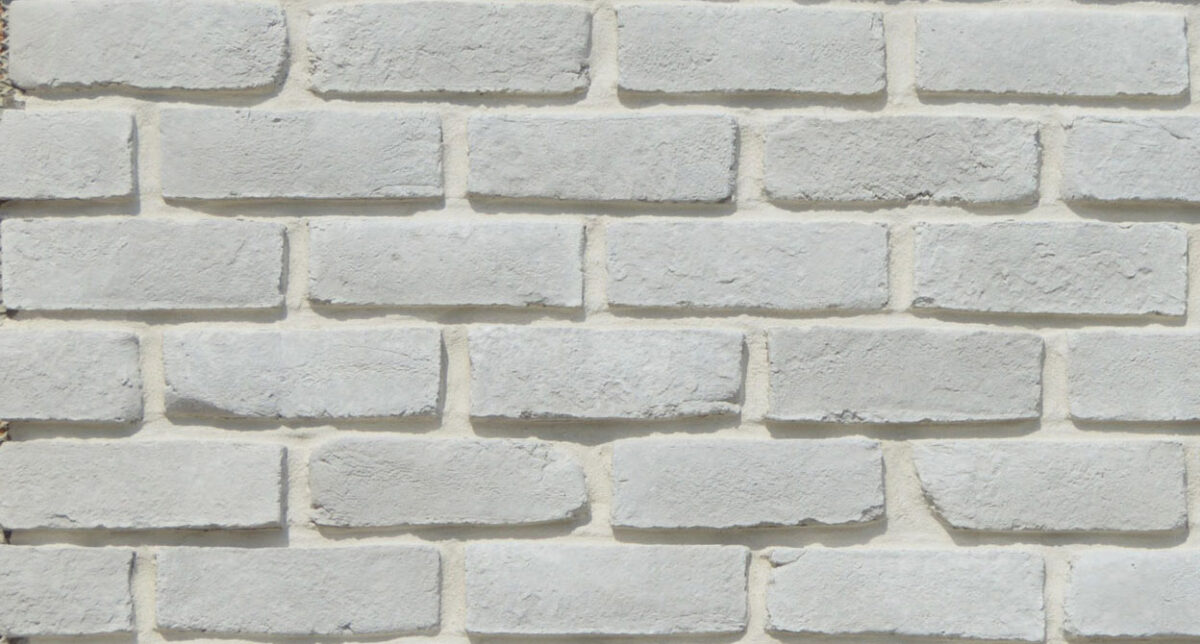 White brick wall with textured stone surface for exterior design.