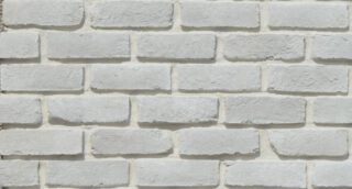 White brick wall with textured stone surface for exterior design.