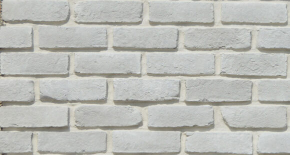 White brick wall with textured stone surface for exterior design.